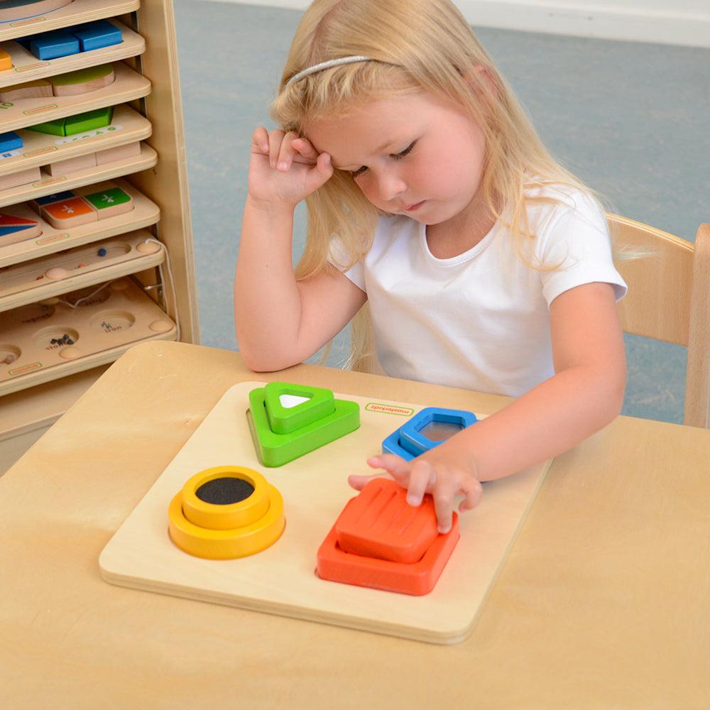 Preschool classroom using sensory blocks for tactile learning exercises.
