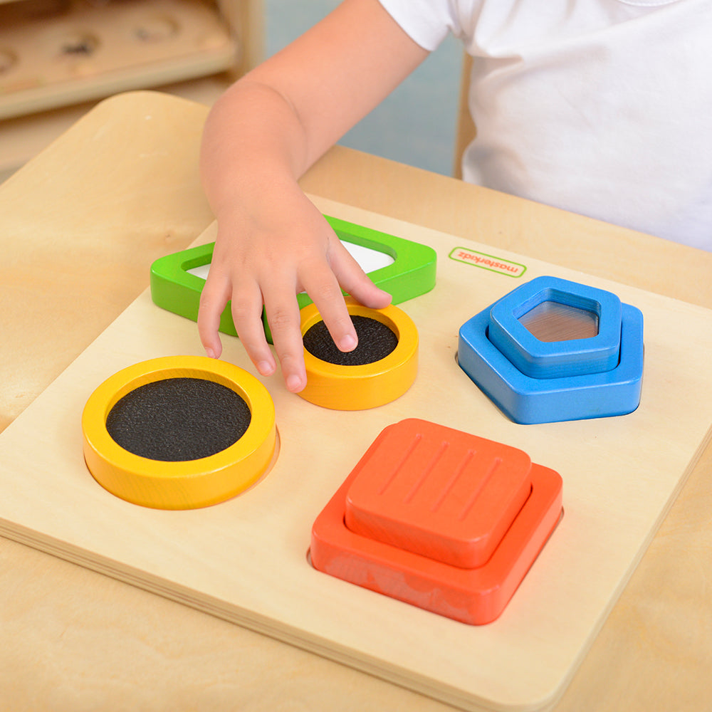 Four pairs of uniquely shaped and colored blocks laid out for matching.