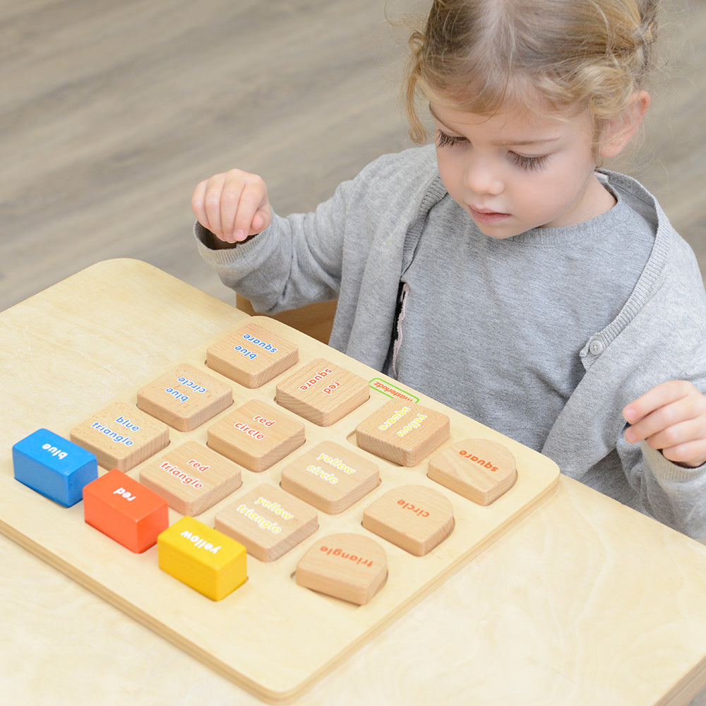 Children matching square blocks with corresponding colour and shape blocks on the board.