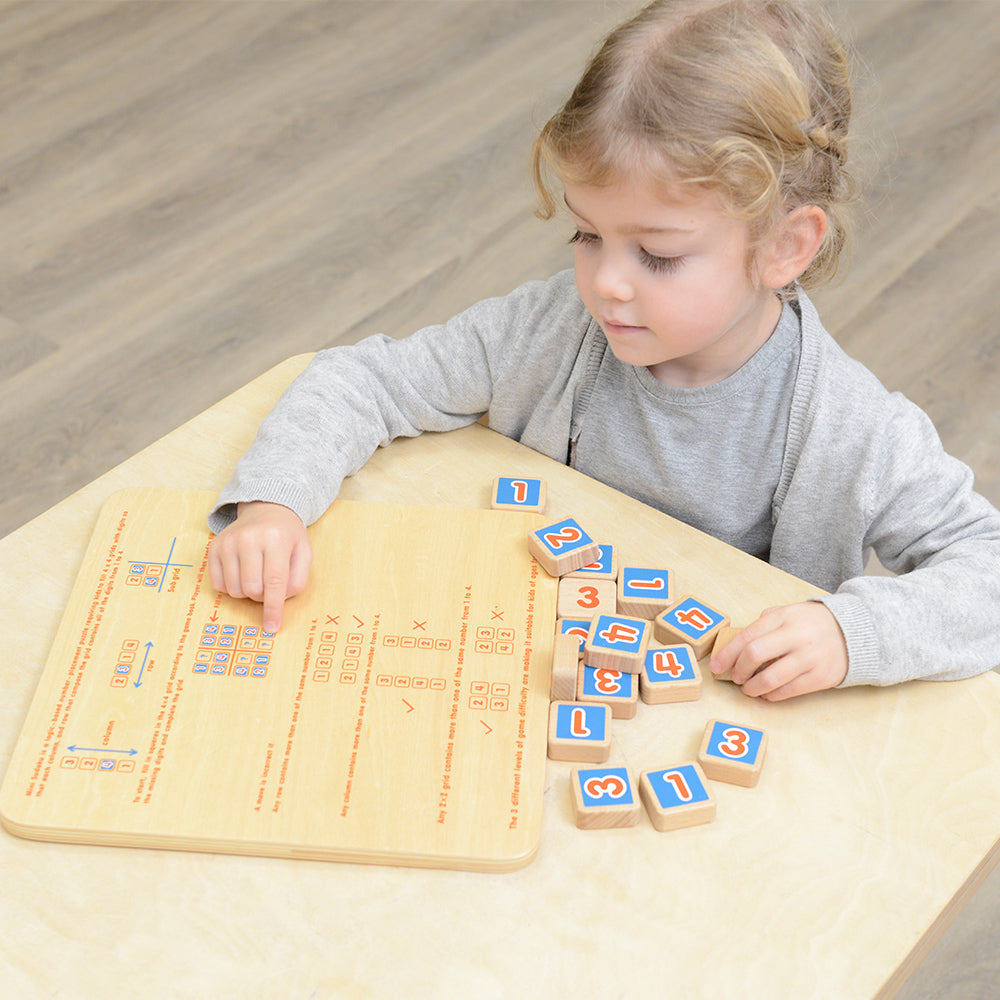 Child playing simplified Sudoku game on Masterkidz board.