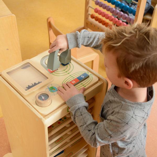 Child exploring magnetic attraction and repulsion between poles.