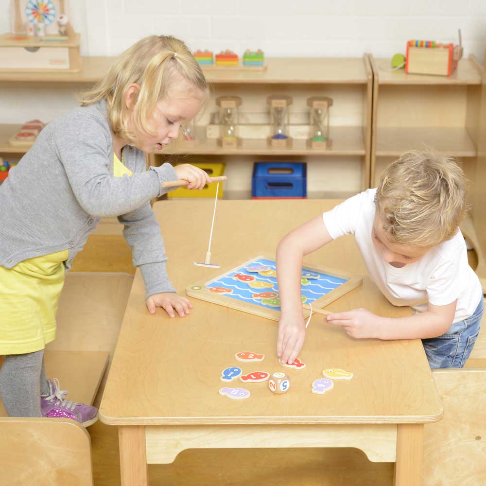 Kids playing with magnetic wooden sea creature fishing set