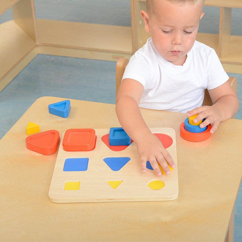 Montessori classroom setup with children sorting and grouping blocks by size and colour.