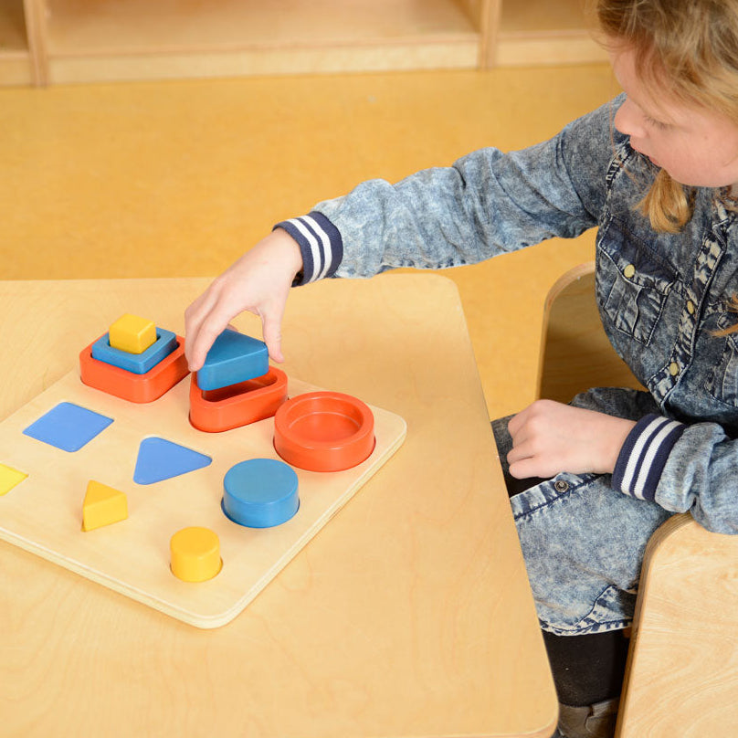 Children matching shapes and colours on the base panel for early learning fun.