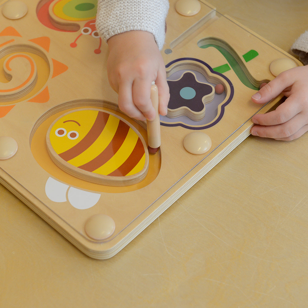 Close-up of butterfly-shaped magnetic track with colourful beads.