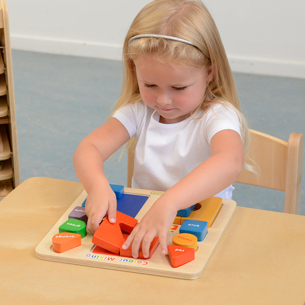 Kids experimenting with combining red, blue, and yellow blocks to create new colours.