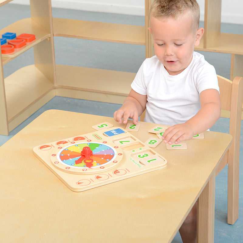 Child placing number tiles to match the digital time display.