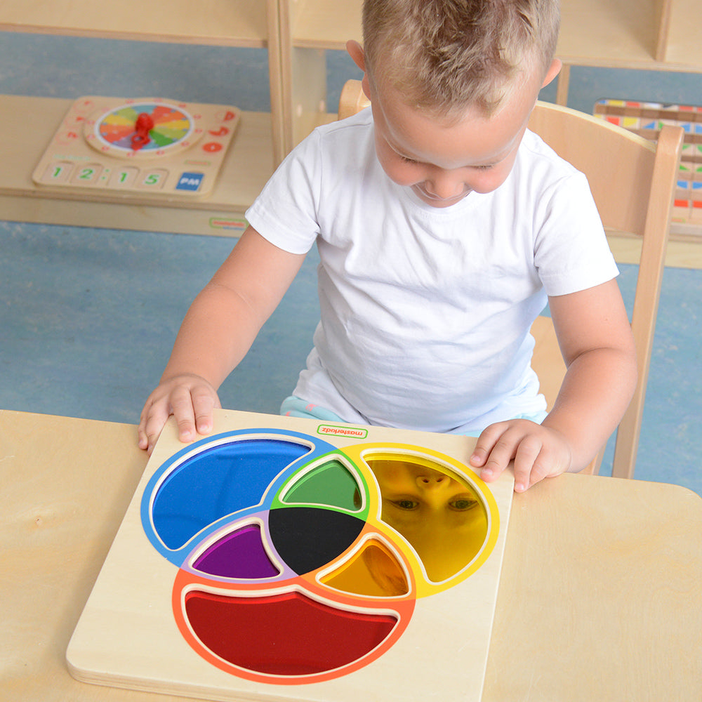 Child exploring colour combinations on the Masterkidz mirror board