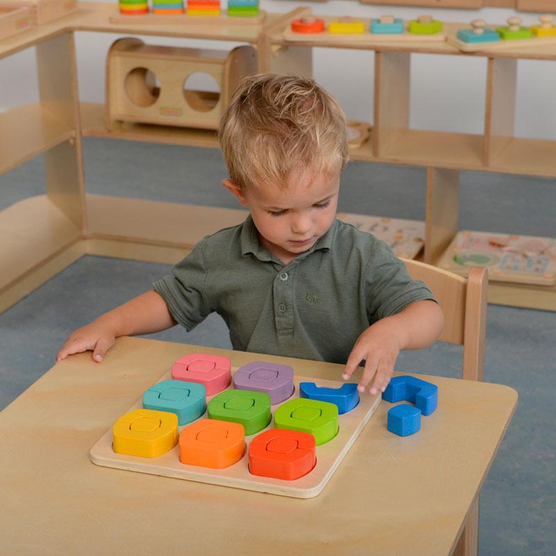 Preschool setup featuring shape and colour sorting blocks.