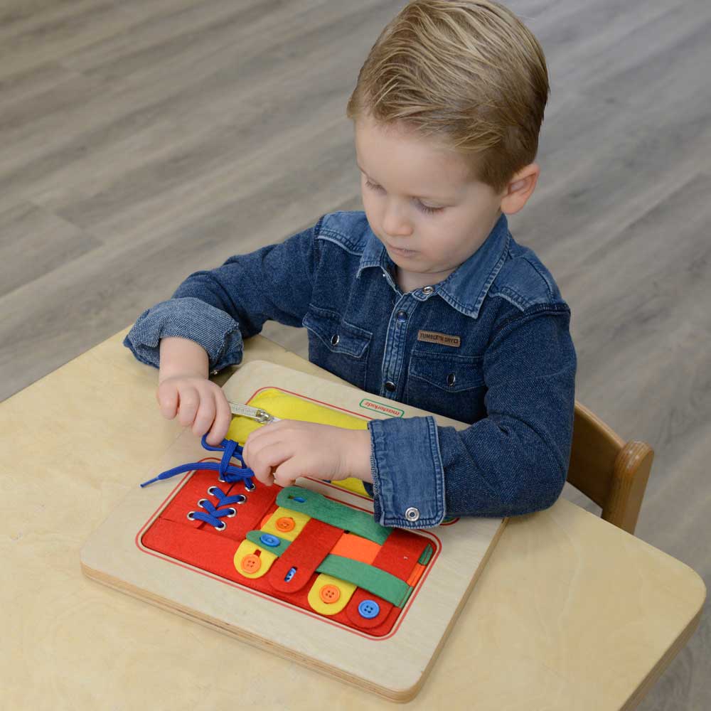 Close-up view of zipper and button training areas on the board.