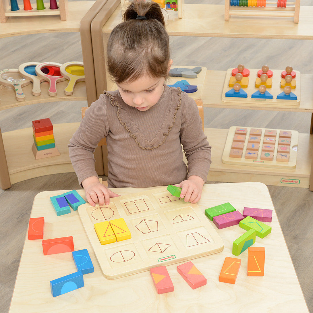 Kids practicing geometry and spatial skills on shape board