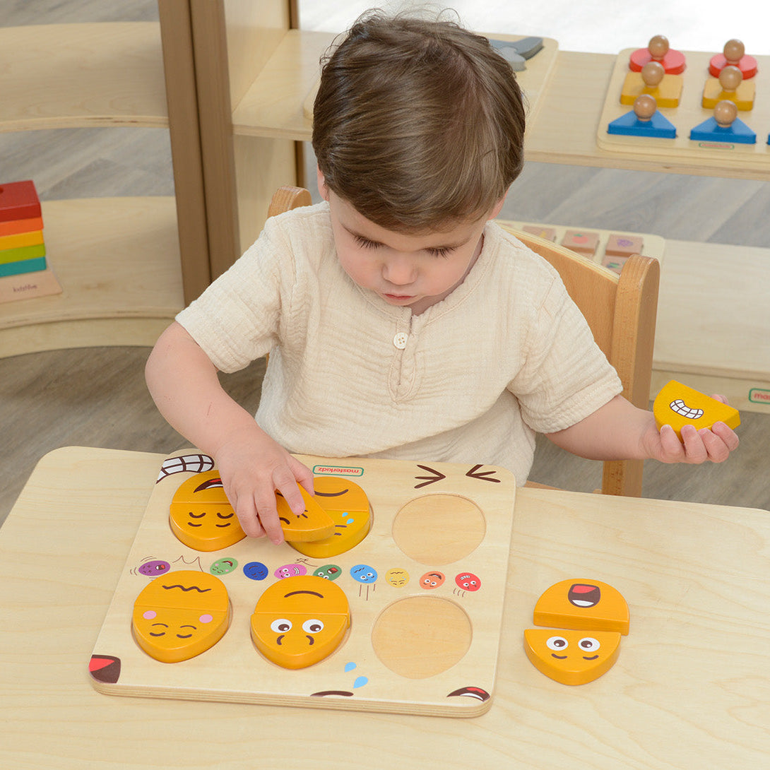 Children exploring facial expressions using the Masterkidz emotional learning toy