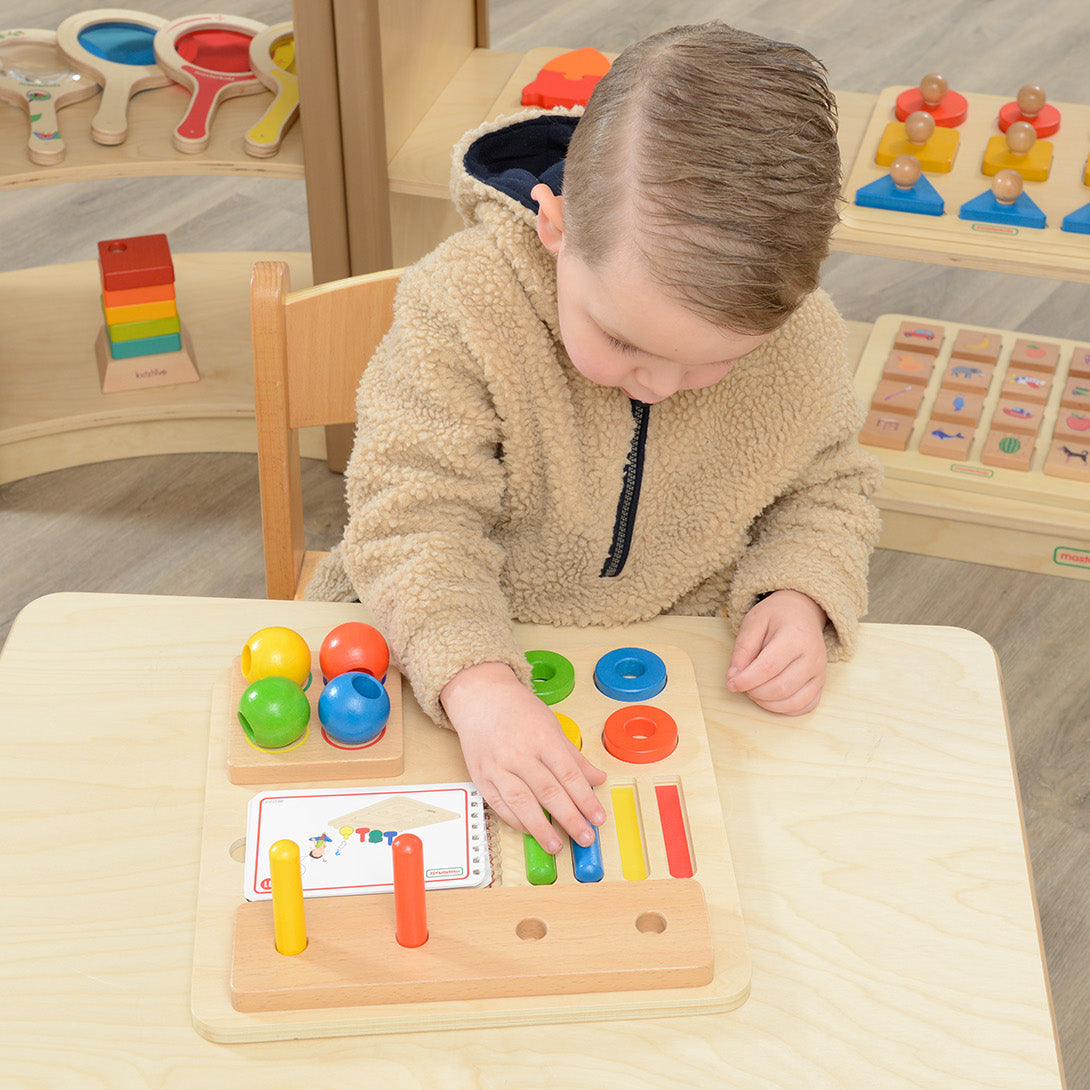Four colour groups showing peg, ring and sphere sets neatly displayed.