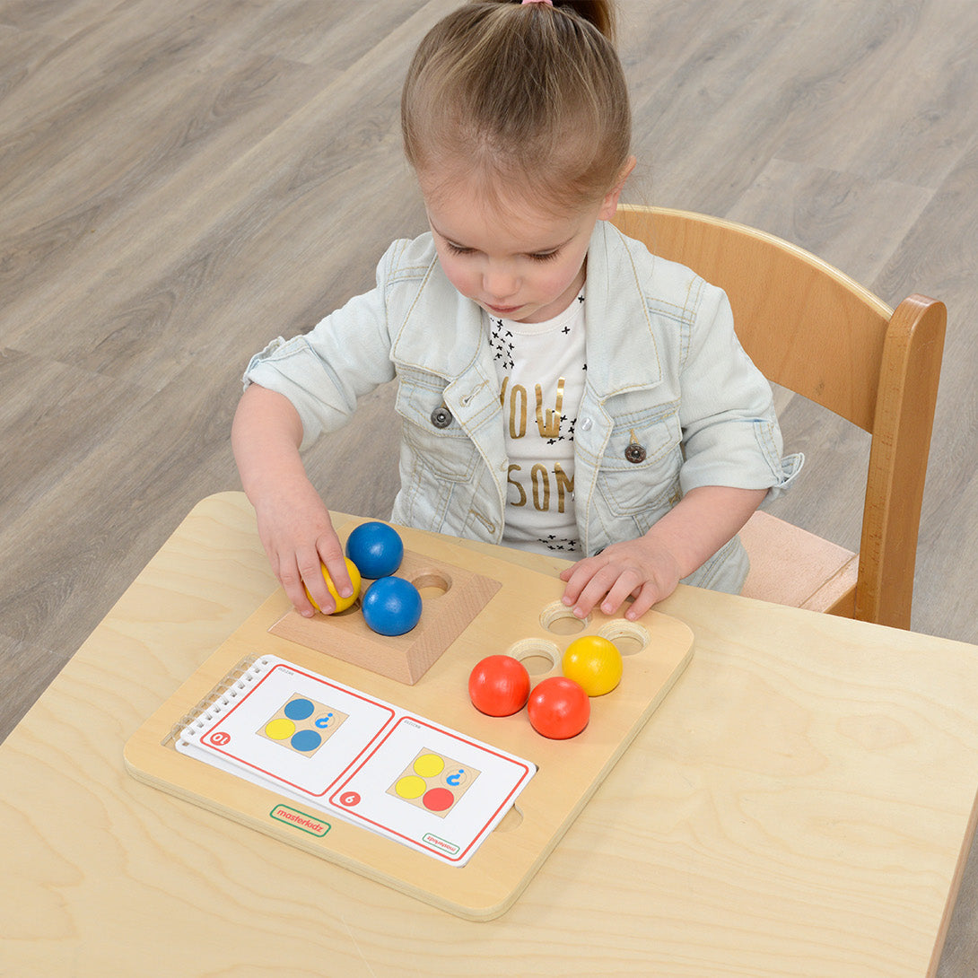 Six weighted wooden balls designed for hands-on balance and stacking activities.
