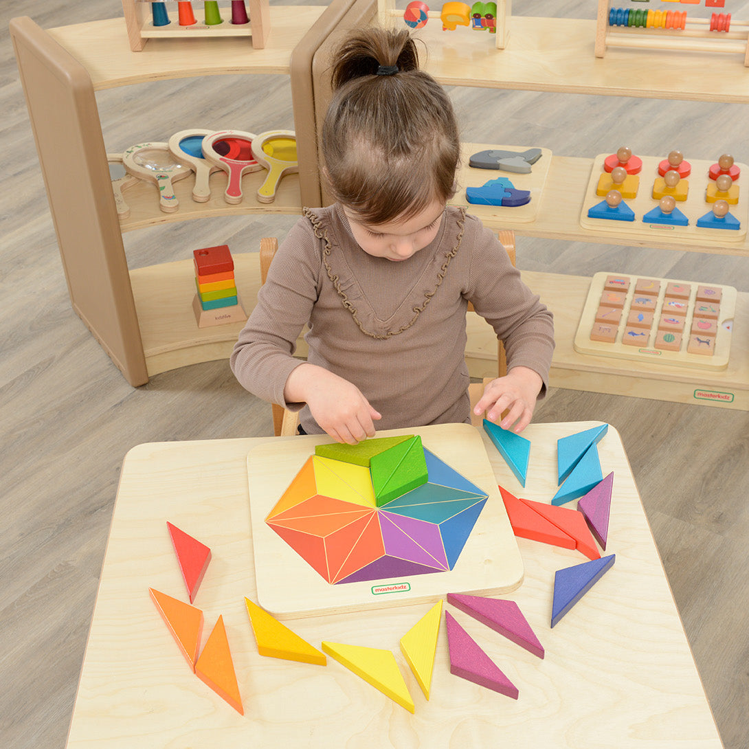 Children building patterns with Masterkidz snowflake-shaped wooden tiles