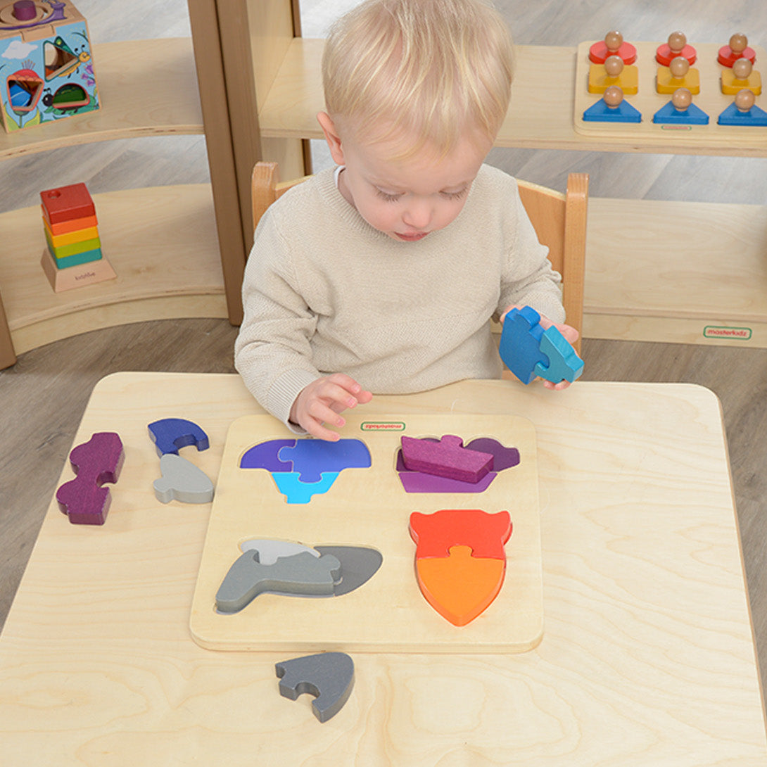 Children assembling transportation-themed pieces like a rocket, car, and aeroplane.