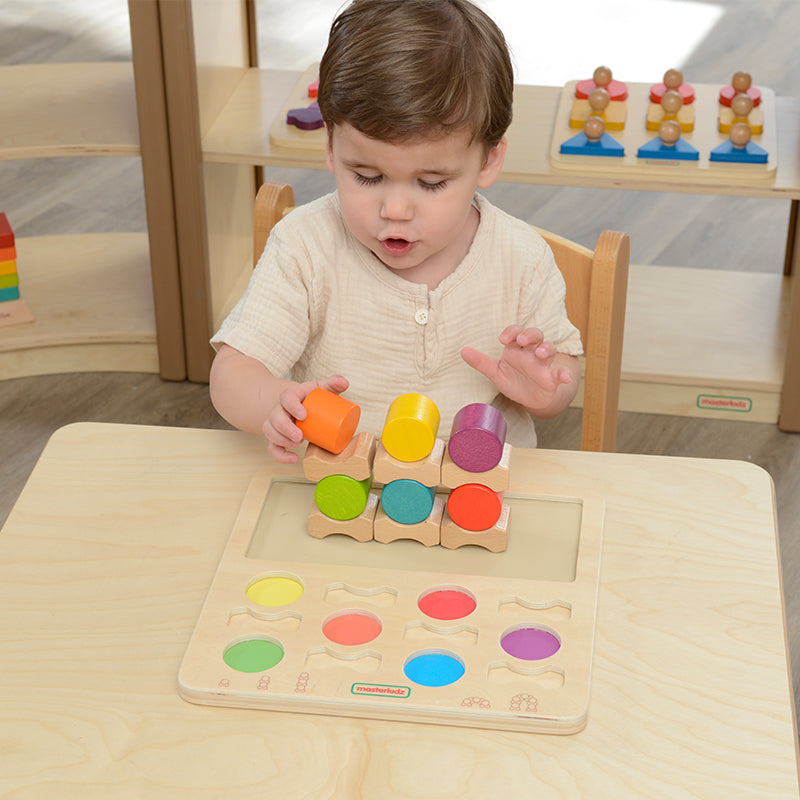 Children playing with Masterkidz Stacking Fun! Challenge Board to develop fine motor skills.