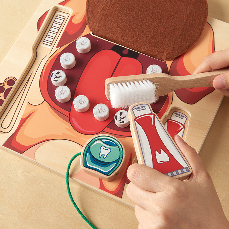 Children developing fine motor skills while cleaning teeth on the Masterkidz oral health board.